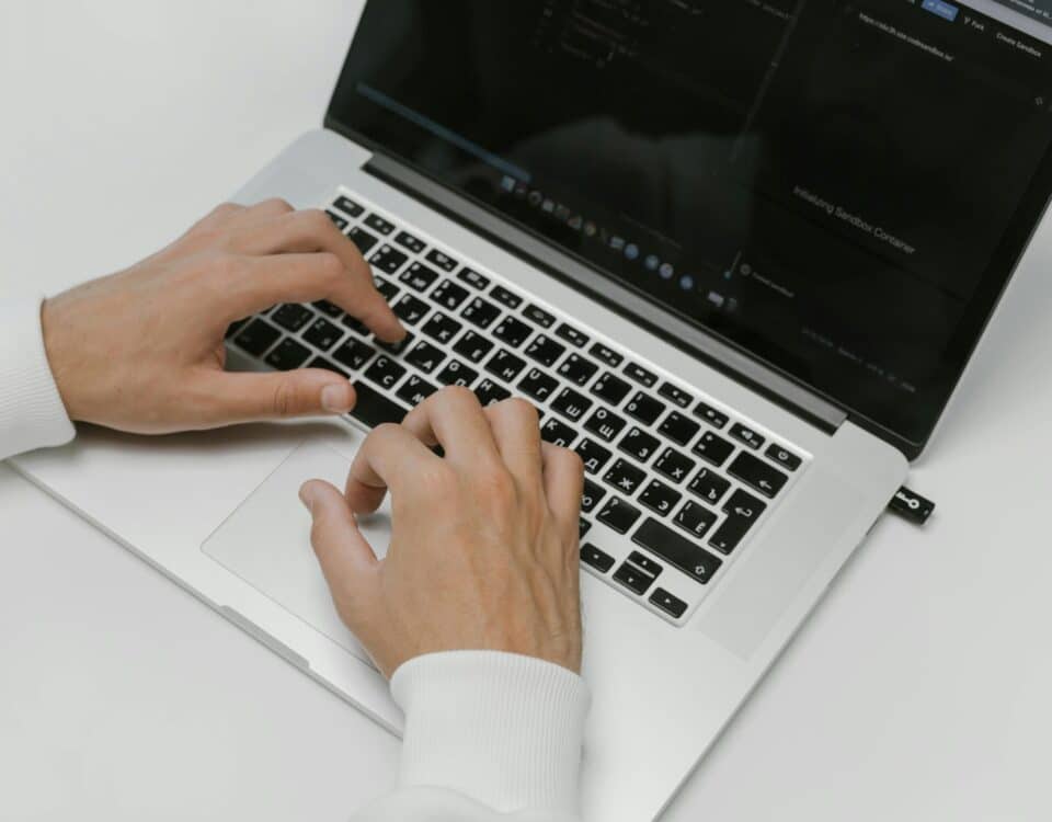 Free Hands on a Laptop Keyboard Stock Photo