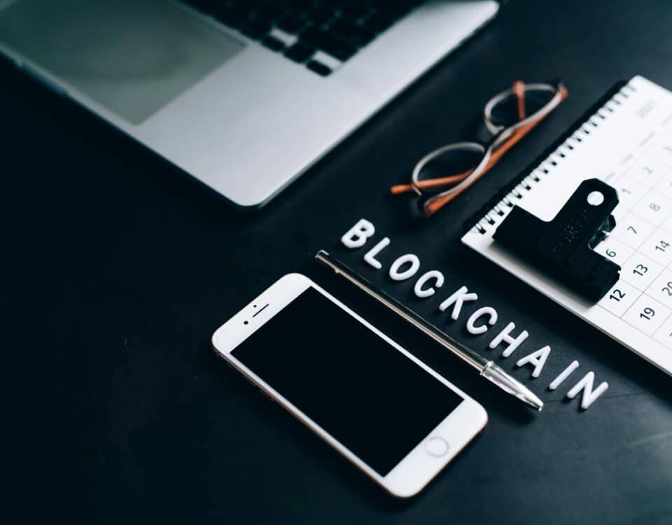 Free Flat lay of a modern digital workspace with blockchain theme, featuring a smartphone and calendar. Stock Photo